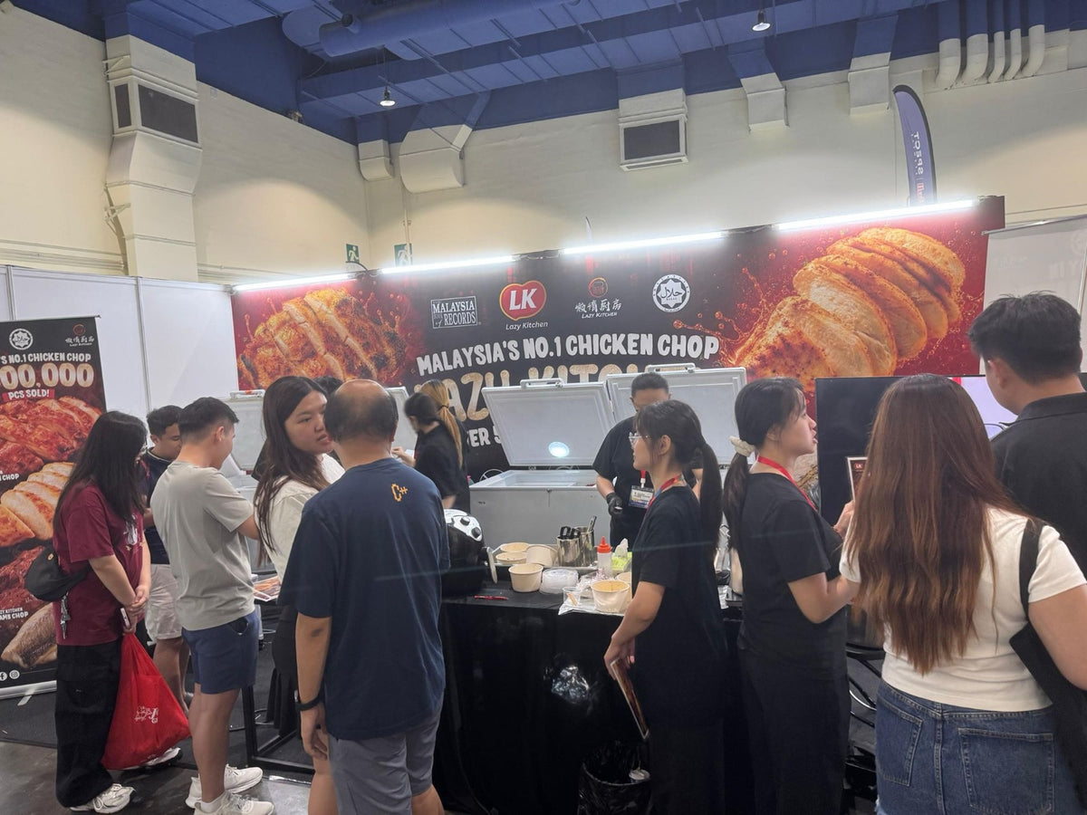 Visitors crowding the Lazy Kitchen booth for samples at a food expo