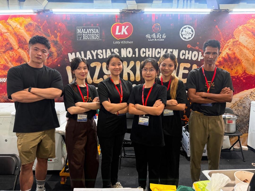 The Lazy Kitchen team in front of their Malaysia Book of Records banner