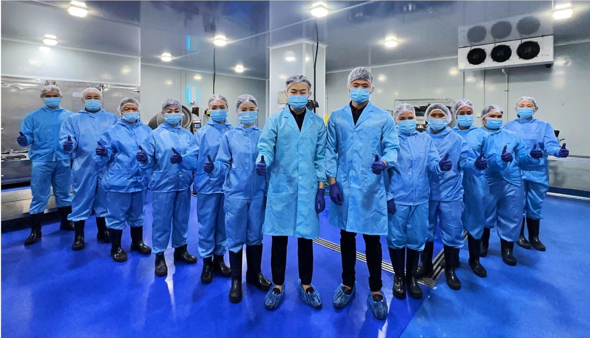 The Lazy Kitchen production team in protective clothing inside the kitchen